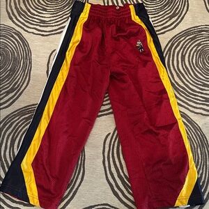 Red Athletic Pants with Yellow and Black Stripes
